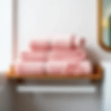 Stylishly arranged pink towels on a bathroom shelf, enhancing decor
