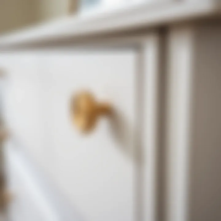 A close-up of a skinny white dresser showcasing its elegant hardware and texture.