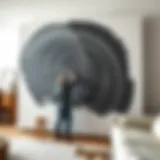 An artist applying bold strokes of paint on a massive canvas